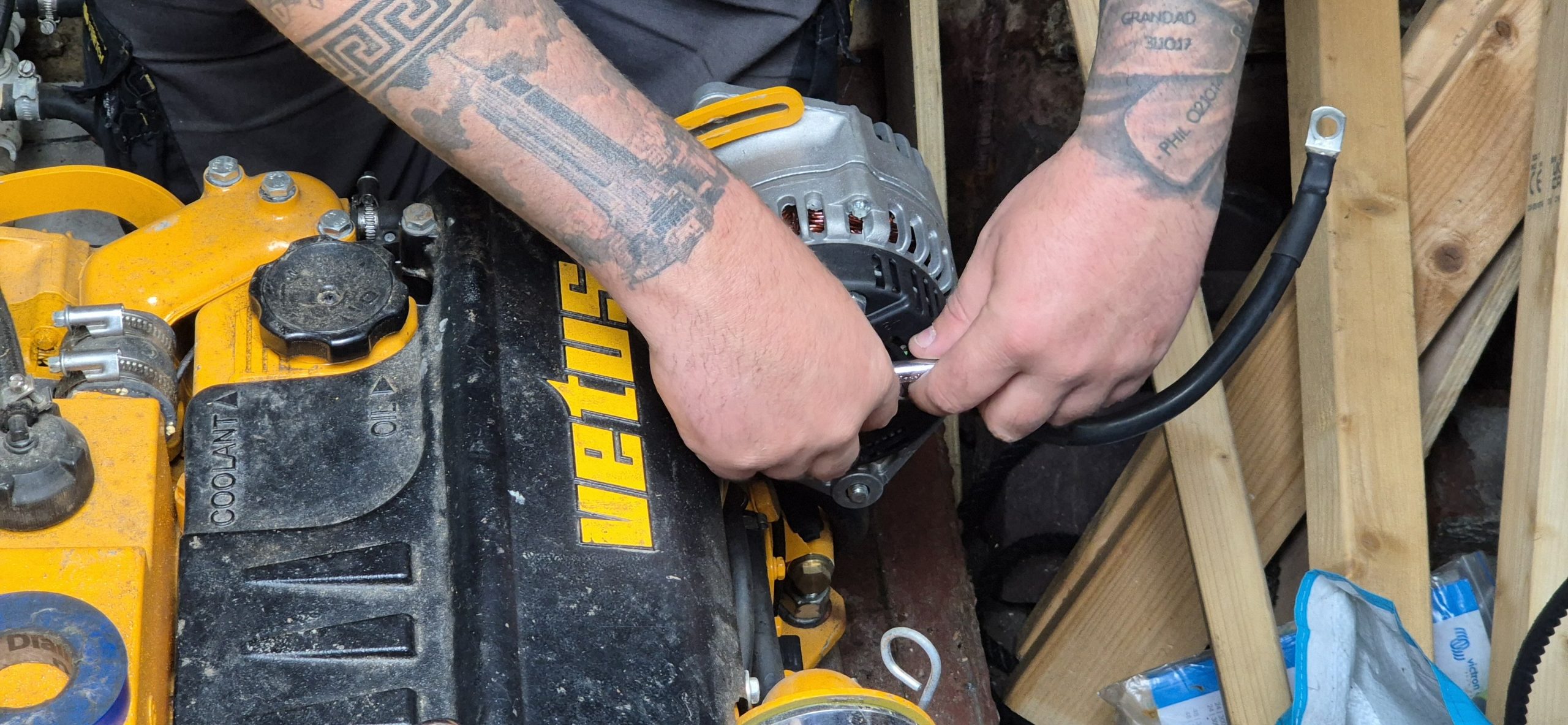 Engineer changing Alternator on Vetus engine